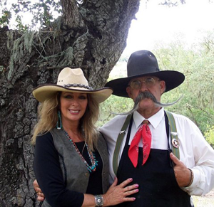 Sue and Billy standing in front of a tree