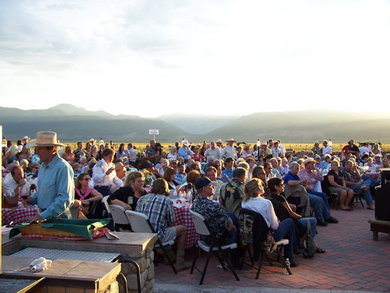 large crowd looking towards to front in front fo blurry hills in the background