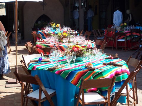 round tables with Mexican blankets as table cloths
