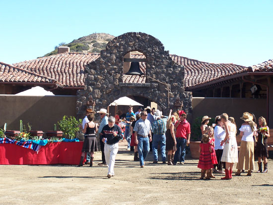 people near stone arch during event with a serving table on the left