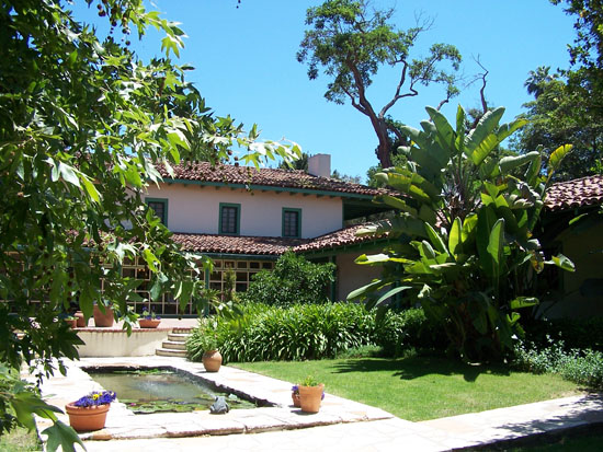 back side of building with pond and lawn