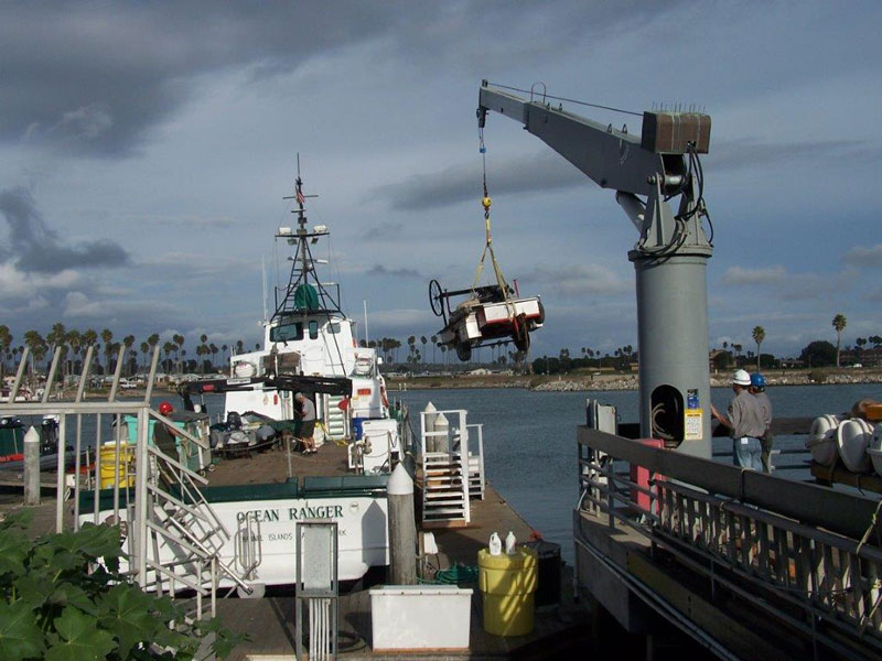 crane loading grill onto a ship for transport