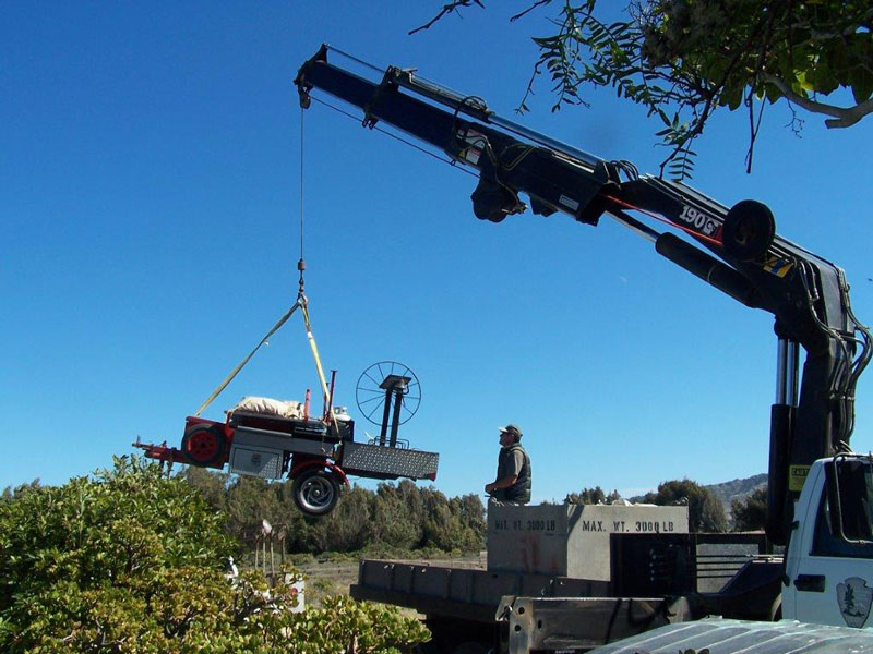 crane lifting grill into place for event