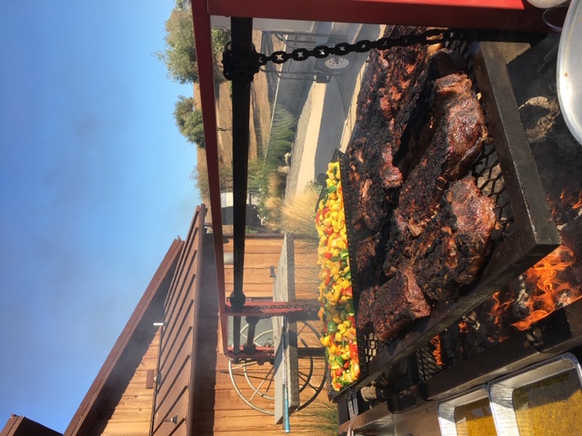 beef and vegetables cooking on a grill