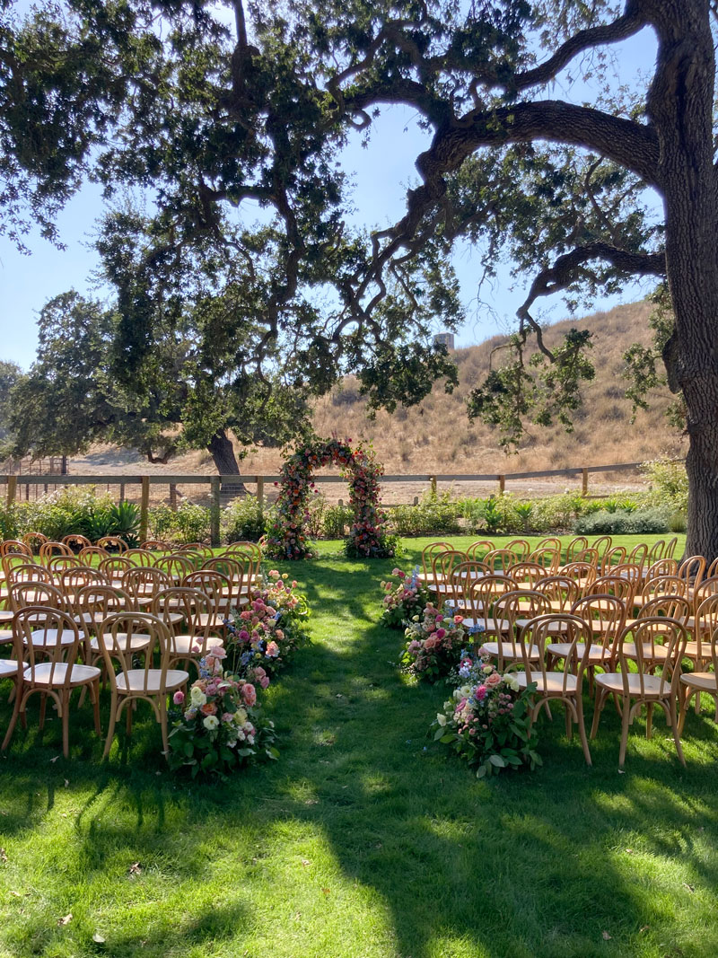outdoor seating with floral arch ready for wedding