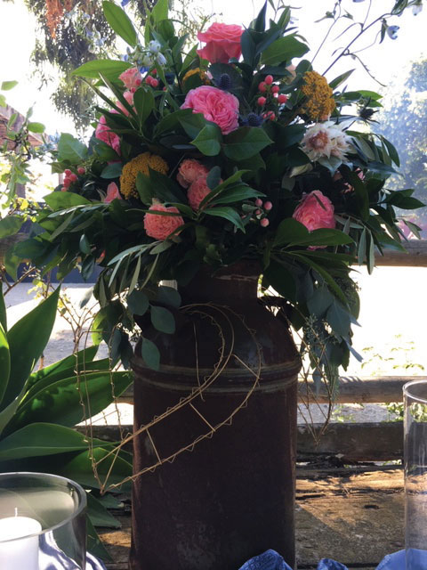 large floral bouquet in milk jug