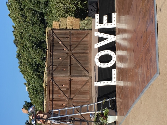 dancefloor setup with LOVE in lights leaning against the stage