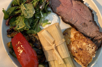 Surf and turf with tamale and salad.