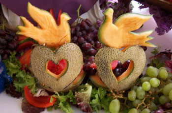 doves and hearts carved out of cantaloupes