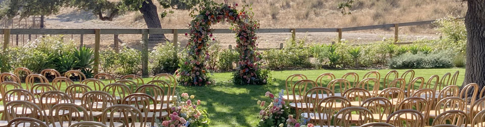 floral arch and rows of empty chairs